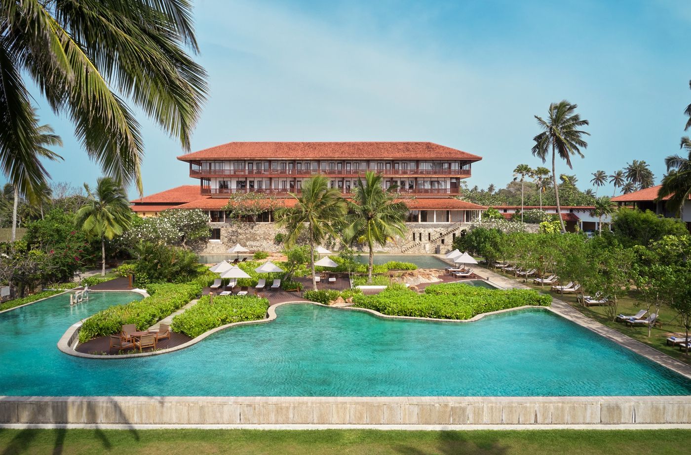 Family-friendly beach resort with pools and palm trees
